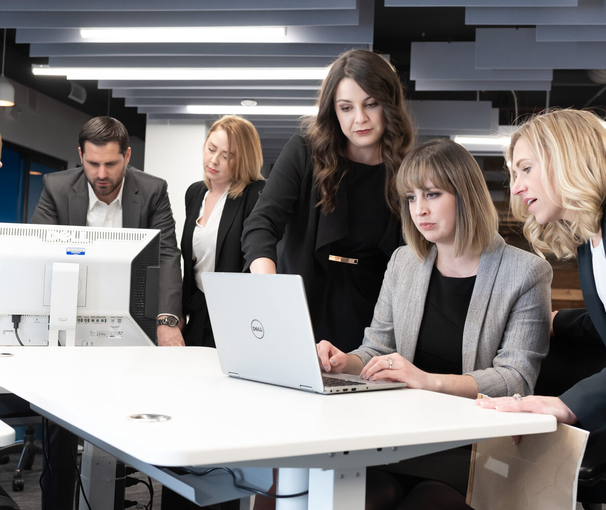 Group of six professionals collaborating in a modern office setting